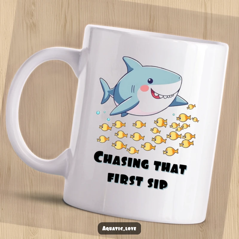Funny mug featuring a playful shark with small fins playfully chasing a small school of tiny, fleeing fish underwater.