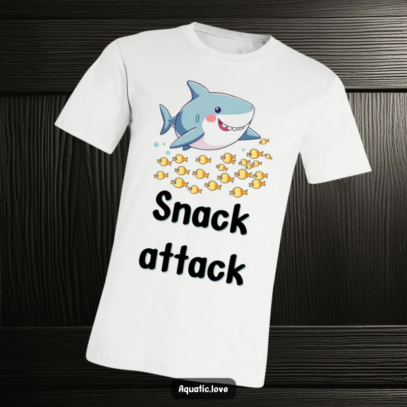 Funny t-shirt depicting a playful shark with small fins energetically chasing a school of tiny fish through the ocean.